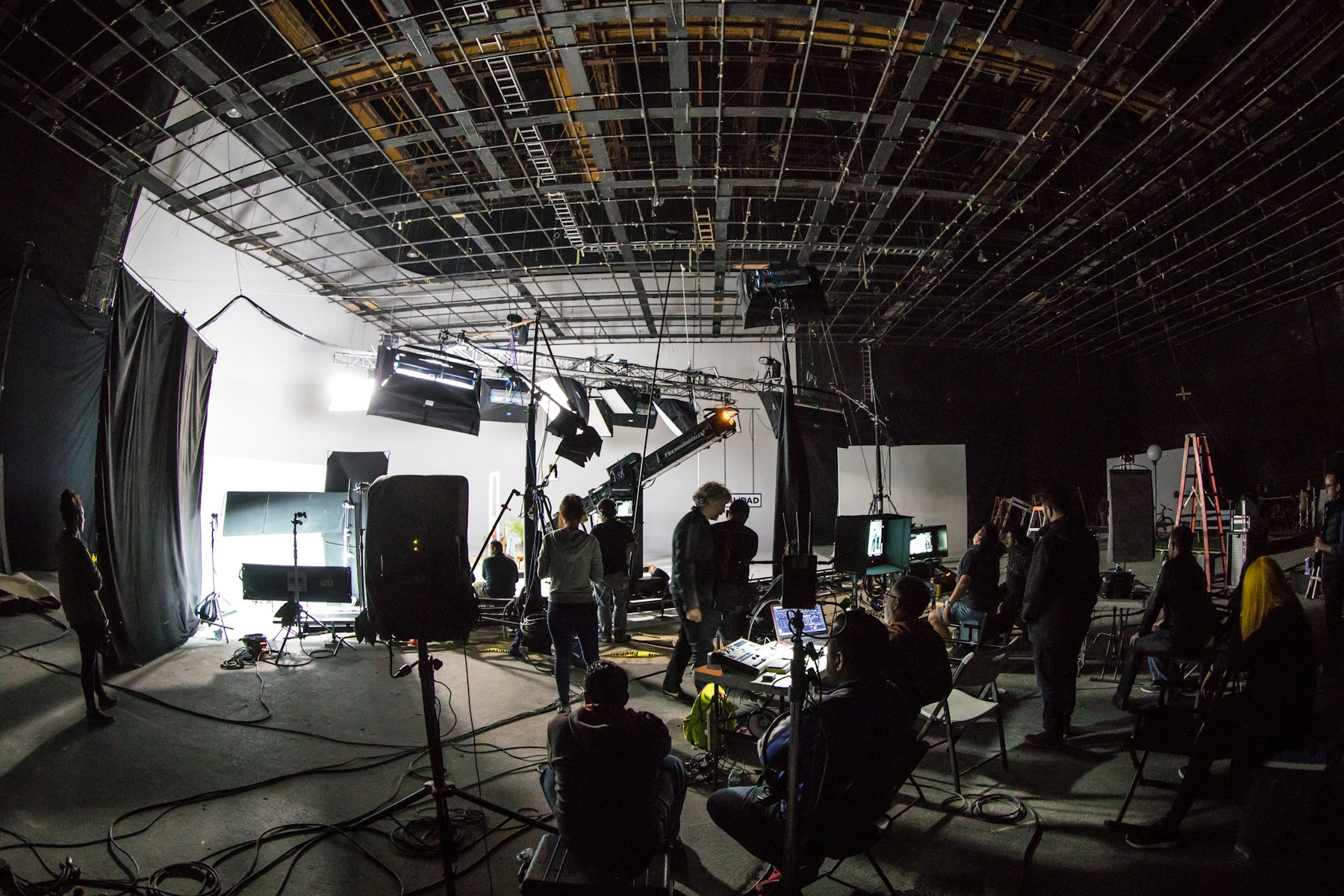 Illustrative studio set with lighting and production crew